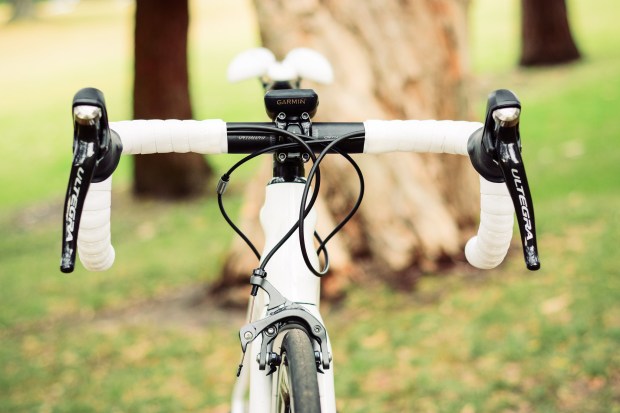     The current line of Ultegra brakes finally come with a reach adjust screw under the hoods and no longer use shims to bring them closer to the bars, which is great for small hands. The screws are soft and plastic, so best not to adjust them with a rusted screwdriver like I did.